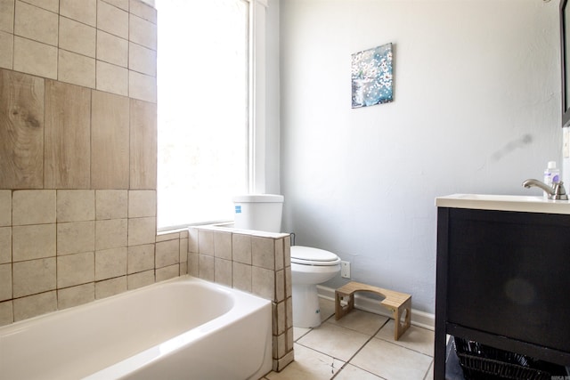 bathroom featuring tile patterned flooring, a garden tub, toilet, and vanity