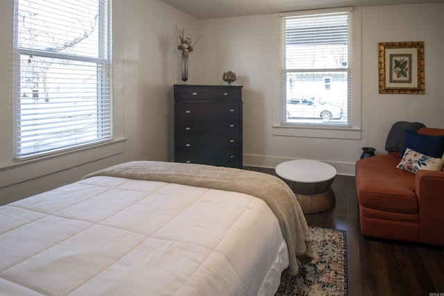 bedroom featuring baseboards and wood finished floors