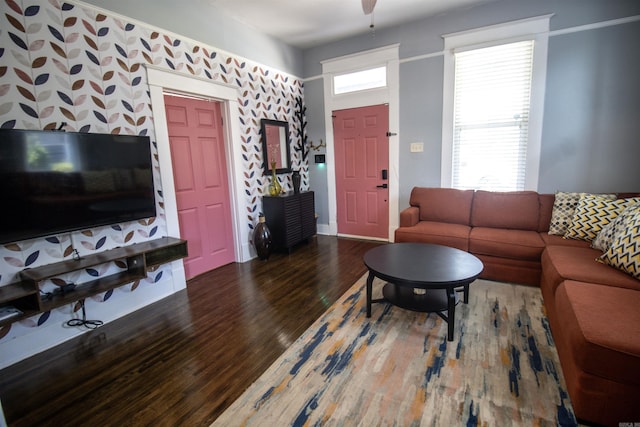 living area featuring a ceiling fan and wood finished floors