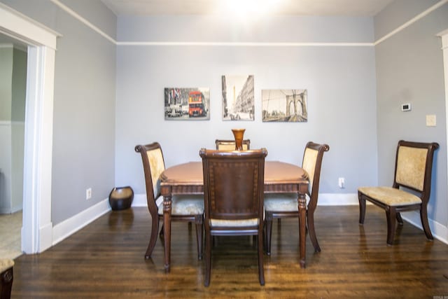 dining area featuring baseboards and wood finished floors