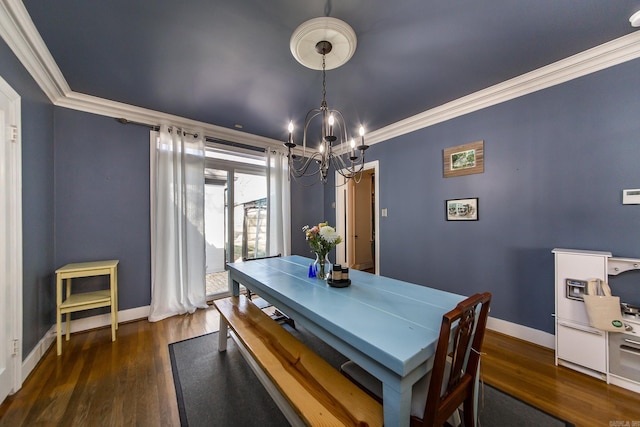 dining area with wood finished floors, a chandelier, and ornamental molding