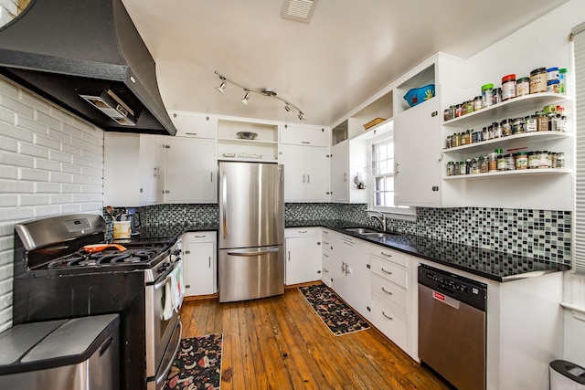 kitchen featuring visible vents, open shelves, dark countertops, appliances with stainless steel finishes, and exhaust hood