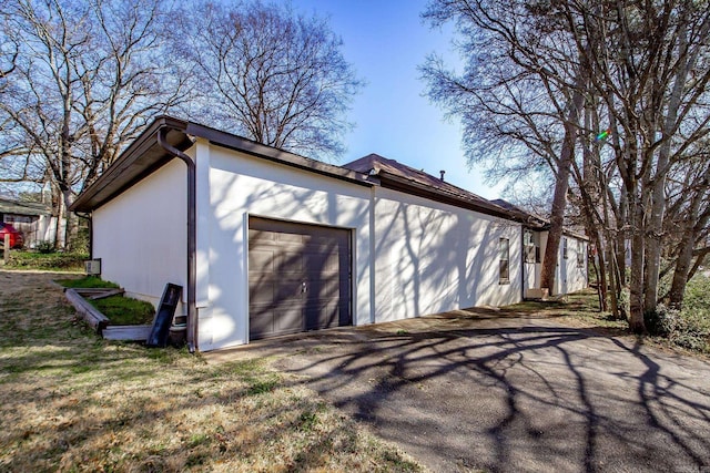 exterior space featuring aphalt driveway and a garage