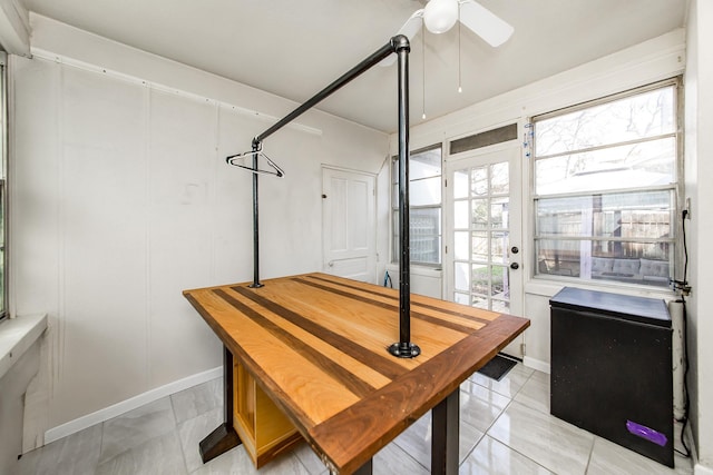 dining room featuring baseboards and ceiling fan