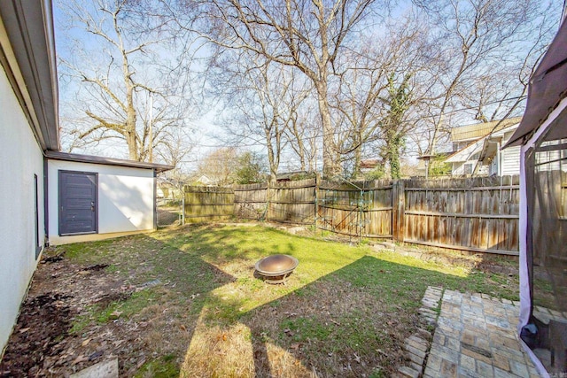 view of yard with a fenced backyard and an outdoor fire pit