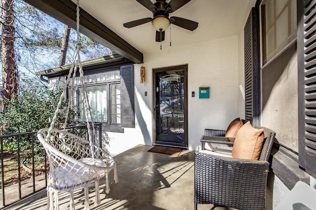 exterior space with stucco siding and a ceiling fan