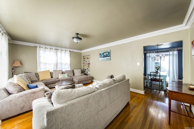 living room with an inviting chandelier, a healthy amount of sunlight, and wood-type flooring