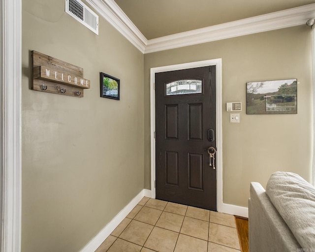 entryway featuring light tile patterned floors, visible vents, crown molding, and baseboards