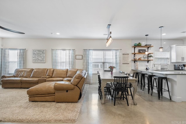 living room with recessed lighting and concrete floors