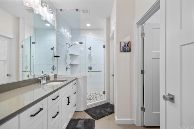 full bath featuring vanity, baseboards, visible vents, recessed lighting, and a shower stall