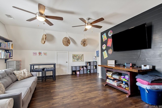 living room with visible vents, lofted ceiling, a ceiling fan, and wood finished floors