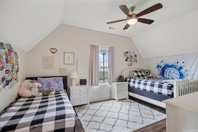 bedroom featuring visible vents, wood finished floors, a ceiling fan, and vaulted ceiling