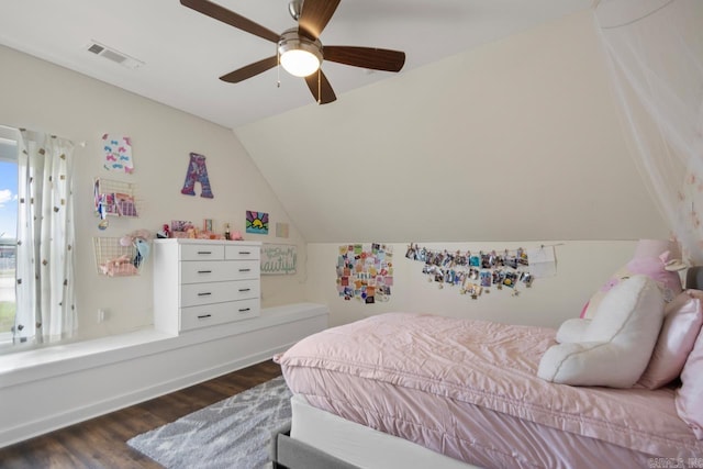 bedroom featuring a ceiling fan, lofted ceiling, wood finished floors, and visible vents