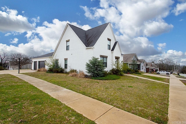 view of property exterior with a garage, a yard, roof with shingles, and driveway