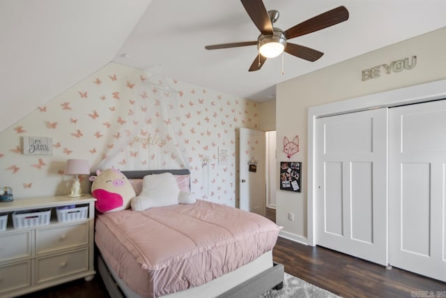 bedroom featuring dark wood-style floors, baseboards, wallpapered walls, ceiling fan, and a closet