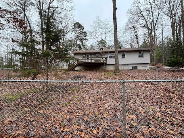 exterior space featuring a wooden deck and a fenced backyard