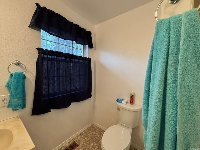 bathroom with visible vents, baseboards, and toilet