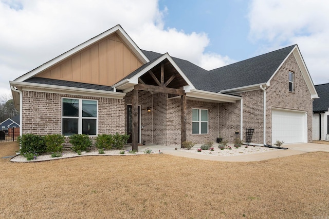 view of front of house featuring a front lawn, board and batten siding, concrete driveway, a shingled roof, and brick siding