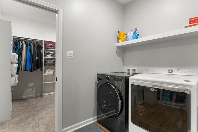 laundry room with baseboards, light carpet, separate washer and dryer, and laundry area