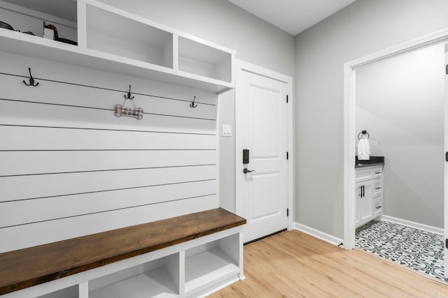 mudroom featuring light wood-type flooring and baseboards