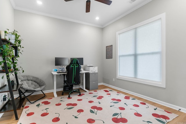 office space with light wood-type flooring, baseboards, ceiling fan, and crown molding