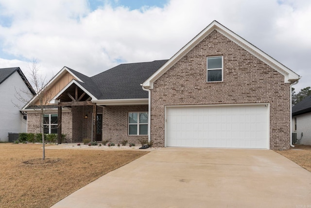 view of front of home with a front lawn, brick siding, driveway, and a shingled roof