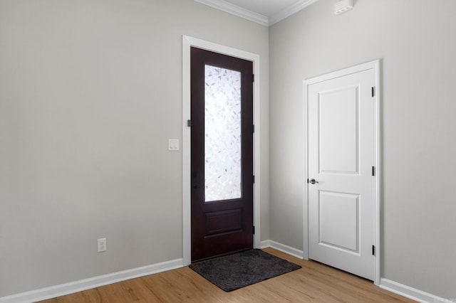 foyer entrance featuring light wood-type flooring, baseboards, and ornamental molding