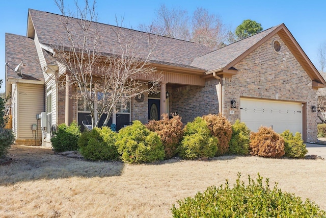 view of front of home featuring an attached garage, brick siding, and roof with shingles