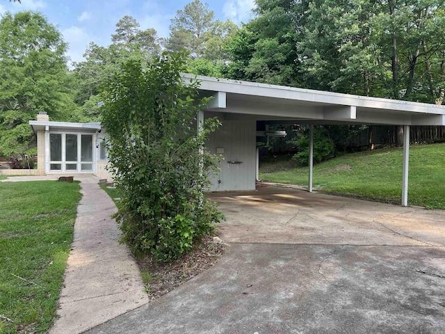 exterior space with a carport and driveway