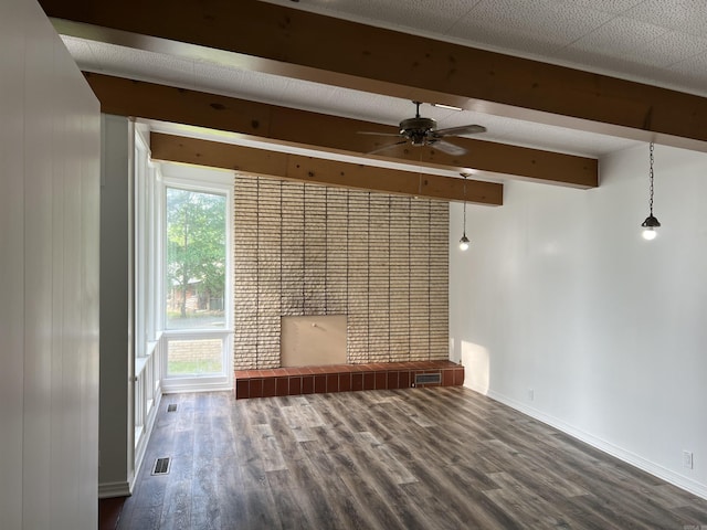 unfurnished room featuring visible vents, beam ceiling, wood finished floors, baseboards, and ceiling fan