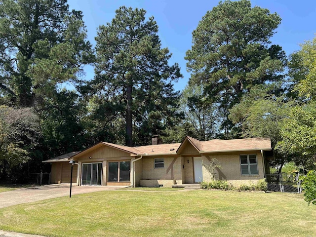 ranch-style home featuring fence, concrete driveway, a front yard, brick siding, and a chimney