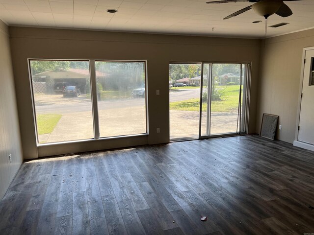 unfurnished living room featuring visible vents, a ceiling fan, and dark wood-style flooring