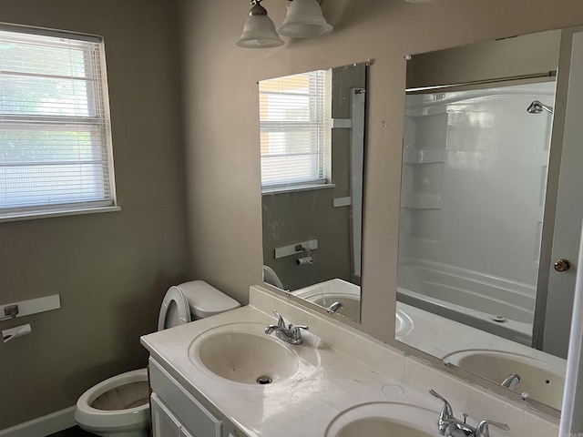 full bath featuring a sink, toilet, and double vanity