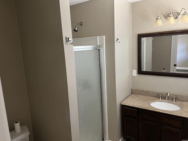 bathroom with a stall shower, toilet, and vanity