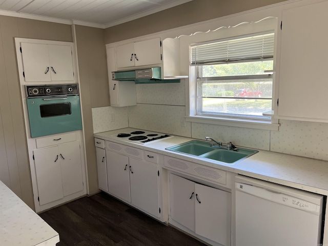 kitchen featuring dark wood-type flooring, extractor fan, light countertops, white appliances, and a sink