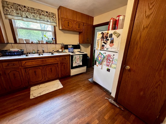 1530 Pearcy Rd, Pearcy, AR 71964 - kitchen with electric stove, a sink, brown cabinetry, light countertops, and freestanding refrigerator