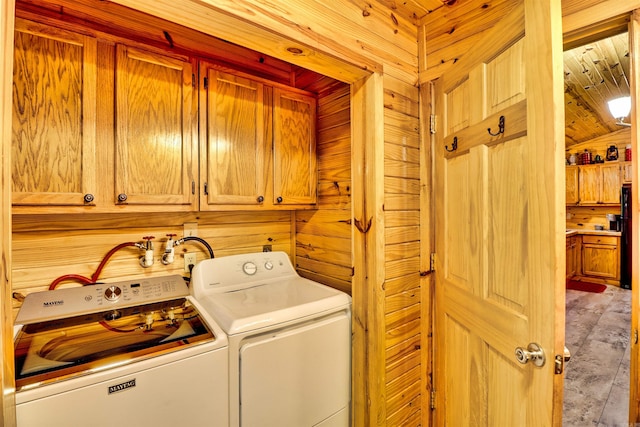 clothes washing area with cabinet space and washer and clothes dryer