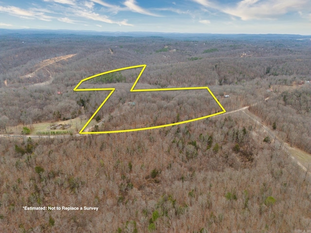 birds eye view of property featuring a view of trees