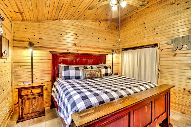 bedroom with light wood-type flooring, wooden walls, wooden ceiling, lofted ceiling, and ceiling fan