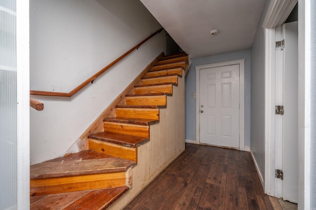 stairs with baseboards and wood finished floors