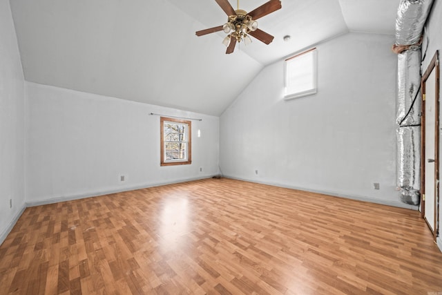 bonus room featuring vaulted ceiling, baseboards, light wood-type flooring, and ceiling fan