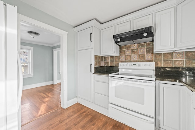 kitchen featuring tasteful backsplash, under cabinet range hood, ornamental molding, white appliances, and white cabinetry