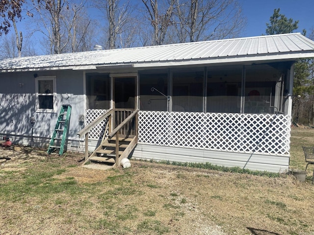 view of front of house with metal roof and a sunroom