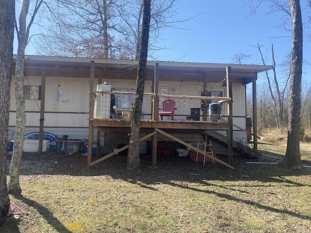 rear view of house featuring a wooden deck