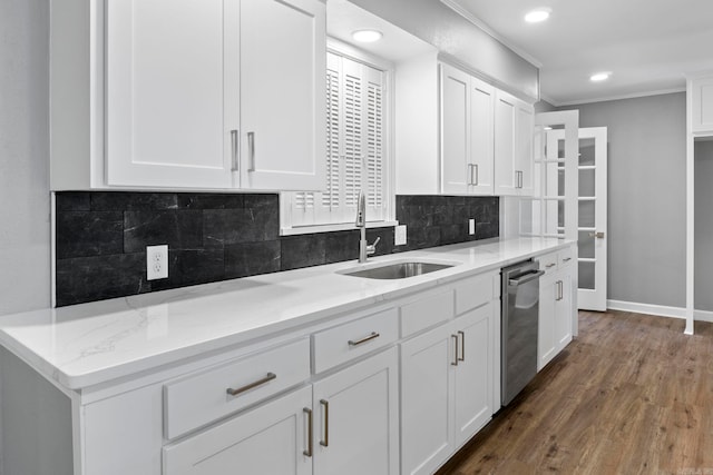 kitchen with white cabinetry, dark wood-type flooring, decorative backsplash, and a sink