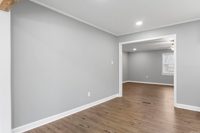 spare room with recessed lighting, ornamental molding, baseboards, and wood finished floors