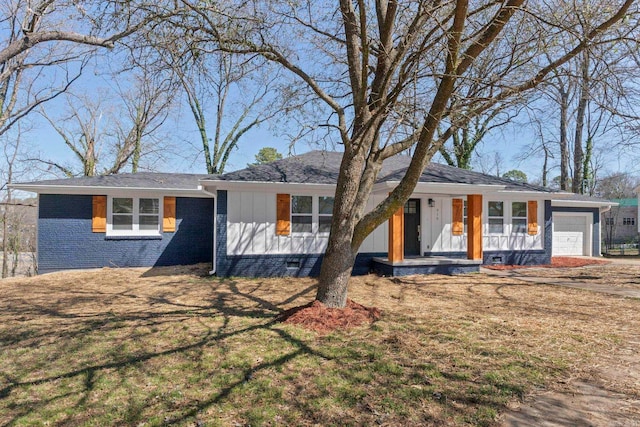 ranch-style home featuring a garage, brick siding, and a front yard