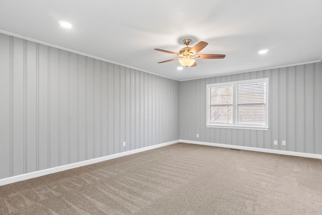 carpeted spare room featuring visible vents, ornamental molding, a ceiling fan, recessed lighting, and baseboards