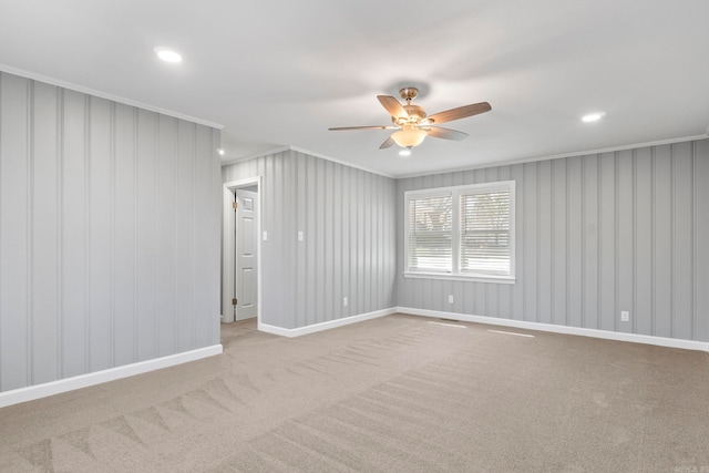 unfurnished room featuring baseboards, crown molding, ceiling fan, and carpet floors