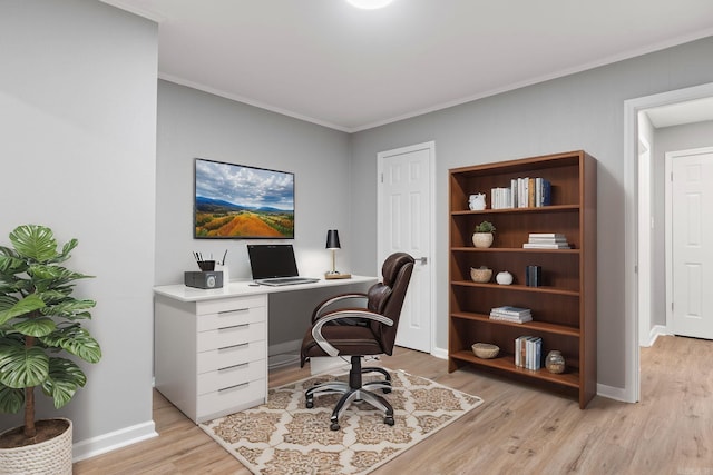 office area featuring crown molding, baseboards, and light wood finished floors